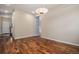 Open-concept living space featuring hardwood floors, neutral walls, and modern lighting at 3389 Willowrun Dr, Castle Rock, CO 80109