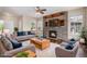 Bright living room featuring a stone fireplace, hardwood floors, and neutral decor at 3389 Willowrun Dr, Castle Rock, CO 80109