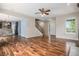 Open-concept living room with hardwood floors, staircase, and natural light at 3389 Willowrun Dr, Castle Rock, CO 80109