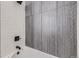 Modern bathroom features a shower and tub with eye-catching tile detail, and matte black hardware at 6491 Barnacle Ct, Boulder, CO 80301