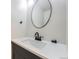 Contemporary bathroom with a round mirror and quartz countertops at 6491 Barnacle Ct, Boulder, CO 80301