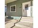 Inviting front entrance with concrete steps and light green siding on a charming single Gathering home at 6491 Barnacle Ct, Boulder, CO 80301