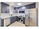Stylish modern kitchen with stainless steel appliances, gray cabinets and white countertops at 6491 Barnacle Ct, Boulder, CO 80301