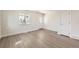 Bright, airy living room with fresh paint, laminate floors, and a large window that provides ample natural light at 6491 Barnacle Ct, Boulder, CO 80301