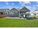 Spacious backyard featuring a well-maintained lawn, patio, and relaxing hot tub at 17788 Olive St, Broomfield, CO 80023