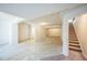 Unfinished basement with concrete floors and stairs leading to the upper level at 17788 Olive St, Broomfield, CO 80023