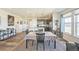 Open dining space with a kitchen island, dining table, and a living area with ample natural light at 17788 Olive St, Broomfield, CO 80023