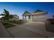 Exterior view of a two-story single-Gathering home at twilight featuring a well-kept lawn and a two-car garage at 17788 Olive St, Broomfield, CO 80023