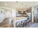 Stylish kitchen boasts granite countertops, stainless appliances, brown cabinets, a large center island with barstool seating at 17788 Olive St, Broomfield, CO 80023