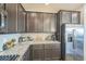 Spacious kitchen features dark cabinets, granite counters, tile backsplash, and stainless steel appliances at 17788 Olive St, Broomfield, CO 80023