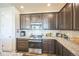 Updated kitchen with stainless steel appliances, granite countertops, tile backsplash and a gas cooktop at 17788 Olive St, Broomfield, CO 80023