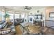 Cozy living room with hardwood floors, fireplace, TV, and sliding glass doors leading to the outdoor patio at 17788 Olive St, Broomfield, CO 80023