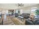 Spacious living room featuring hardwood floors, comfortable seating, and a seamless flow to the kitchen and dining area at 17788 Olive St, Broomfield, CO 80023