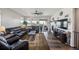 Spacious living room featuring modern decor, hardwood floors, a cozy fireplace, and a sliding glass door to the patio at 17788 Olive St, Broomfield, CO 80023