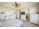 Bright main bedroom featuring a ceiling fan, television, and an ensuite bathroom at 17788 Olive St, Broomfield, CO 80023
