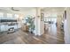 Well-lit office space with hardwood floors, offering a functional workspace adjacent to other living areas at 17788 Olive St, Broomfield, CO 80023