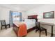 Well-lit bedroom with a wood frame bed, desk, and views of the snowy exterior at 303 Pelican Cir # 1901, Breckenridge, CO 80424