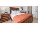 Bedroom featuring a wood frame bed, nightstand, and orange throw blanket at 303 Pelican Cir # 1901, Breckenridge, CO 80424