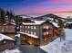A charming mountain condo complex with covered parking and outdoor decks covered in snow at 303 Pelican Cir # 1901, Breckenridge, CO 80424