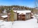 Exterior view of the multi-story condo building in a snowy, wooded area at 303 Pelican Cir # 1901, Breckenridge, CO 80424