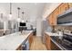 A modern kitchen that opens to living room with breakfast bar and stainless steel appliances at 303 Pelican Cir # 1901, Breckenridge, CO 80424