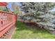 Lawn next to a wooden deck. A large tree covers part of the deck at 10908 Eagle Run Dr, Parker, CO 80138