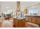 Modern kitchen showcasing granite countertops, island cooktop, and opens into the living space at 10908 Eagle Run Dr, Parker, CO 80138