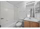 Standard bathroom with tub-shower, toilet and vanity with sink and a mirror at 10685 Cherrybrook Cir, Highlands Ranch, CO 80126