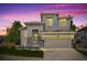 Charming two-story home with stone accents and a two-car garage at dusk at 10685 Cherrybrook Cir, Highlands Ranch, CO 80126