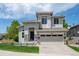 Attractive two-story home boasting stone details, a two-car garage, and green lawn at 10685 Cherrybrook Cir, Highlands Ranch, CO 80126