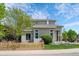 Charming two-story home with a well-manicured lawn, a beautiful tree, and a wooden fence at 10685 Cherrybrook Cir, Highlands Ranch, CO 80126