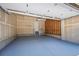 Garage with a blue floor, white door to the home, and unfinished walls at 10685 Cherrybrook Cir, Highlands Ranch, CO 80126