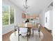 Kitchen and dining area features hardwood floors, modern lighting, and a large window at 10685 Cherrybrook Cir, Highlands Ranch, CO 80126