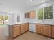 Open-concept kitchen boasts abundant counter space, wood cabinetry, and modern appliances at 10685 Cherrybrook Cir, Highlands Ranch, CO 80126