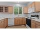 Kitchen with natural wood cabinets, white countertops, and stainless steel appliances at 10685 Cherrybrook Cir, Highlands Ranch, CO 80126