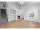 Bright living room with a fireplace, built-in shelving, and open floor plan at 10685 Cherrybrook Cir, Highlands Ranch, CO 80126