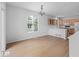 An open-concept living and kitchen area features hardwood floors, a chandelier, and ample natural light at 10685 Cherrybrook Cir, Highlands Ranch, CO 80126