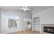 Bright and airy living room featuring a fireplace, built-in shelving, and hardwood floors at 10685 Cherrybrook Cir, Highlands Ranch, CO 80126