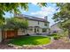 Large backyard featuring green grass and mature trees at 12752 W Dakota Ave, Lakewood, CO 80228