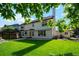 Well maintained backyard with lush green grass and mature trees at 12752 W Dakota Ave, Lakewood, CO 80228