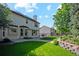 Spacious backyard featuring lush lawn, patio, and beautifully landscaped garden at 12752 W Dakota Ave, Lakewood, CO 80228