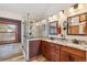 Renovated primary bathroom features a walk-in shower and dual sink vanity at 12752 W Dakota Ave, Lakewood, CO 80228
