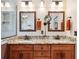 Elegant bathroom featuring a granite countertop, double sinks, and decorative mirrors at 12752 W Dakota Ave, Lakewood, CO 80228