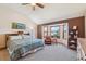 Inviting bedroom features a vaulted ceiling, brown accent wall, and a cozy reading nook by the window at 12752 W Dakota Ave, Lakewood, CO 80228