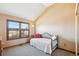 Cozy bedroom with a large window, plush carpet, and a daybed with decorative pillows at 12752 W Dakota Ave, Lakewood, CO 80228