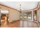 Bright dining room with hardwood floors and expansive windows, seamlessly flowing into the kitchen area at 12752 W Dakota Ave, Lakewood, CO 80228