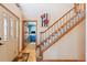 Inviting entryway with hardwood floors, staircase, and office space through doorway at 12752 W Dakota Ave, Lakewood, CO 80228