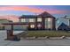 Beautiful brick home featuring a manicured lawn, a two-car garage, and solar panels at 12752 W Dakota Ave, Lakewood, CO 80228
