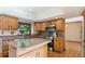 Functional kitchen with wood cabinets, stainless appliances, an island, and hardwood floors at 12752 W Dakota Ave, Lakewood, CO 80228