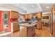 Well-lit kitchen with oak cabinets, stainless appliances, and center island at 12752 W Dakota Ave, Lakewood, CO 80228